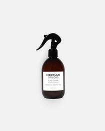 Hercule Studio Probiotic-Enriched Sanitizing Spray for Exercise Mats, a stylish 2-in-1 bottle designed to clean yoga and fitness mats and create an energizing atmosphere, made in France
