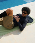 Galé Hercule Studio midnight black mat in a lifestyle setting, black 3-in-1 mini mat for Pilates and yoga sessions, portable accessory made in France, and pistachio green exercise