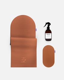 Hercule Studio terracotta essential bundle including the Archy arch-shaped sport mat, the Galé 3-in-1 comfort pad for knees and elbows and the sanitizing spray, durable Made in France Pilates and fitness bundle, packshot of grouped products