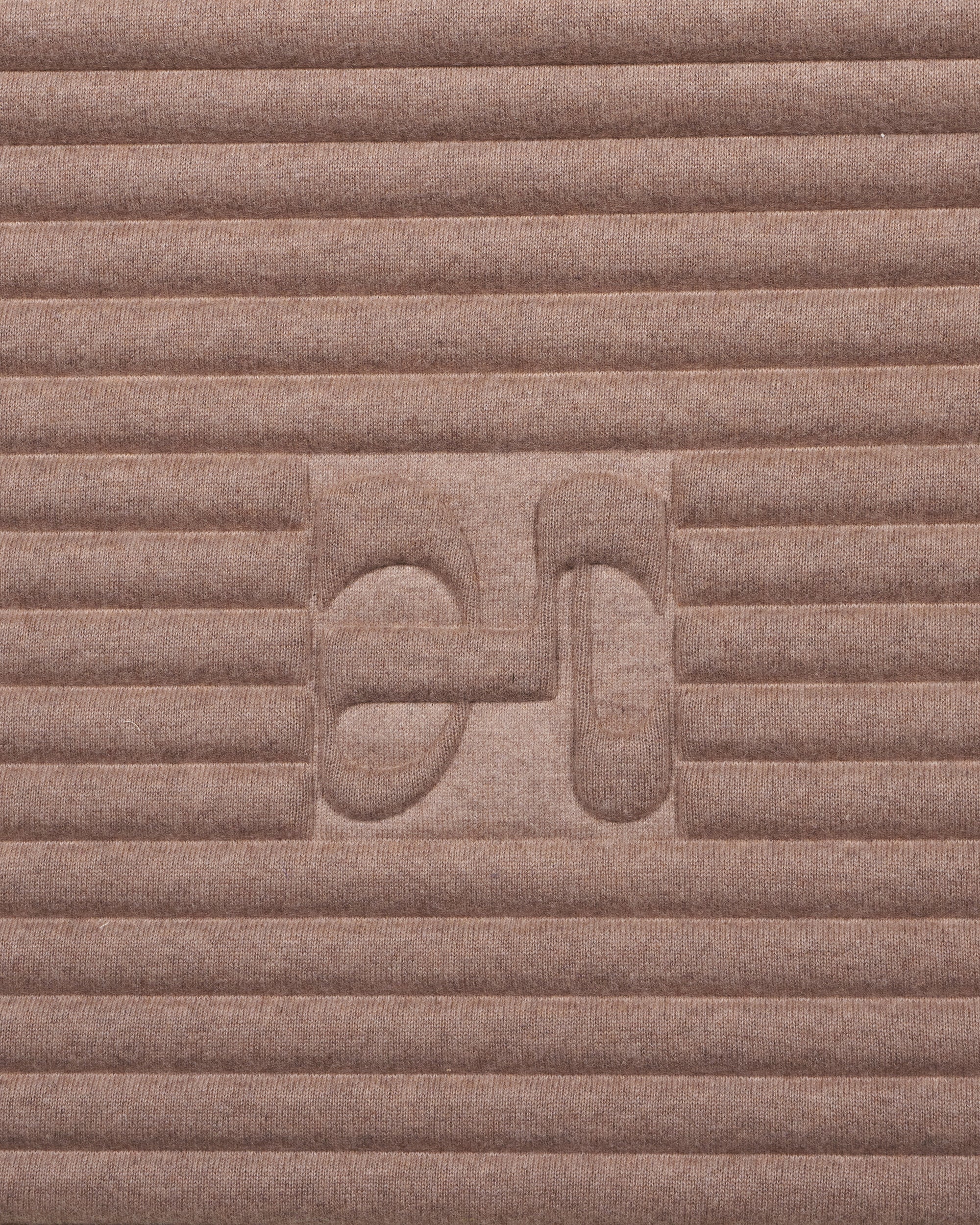 Close-up on the beige cashmere texture and embossed H logo of the Hercule Studio x From Future Sandy Brown sport mat