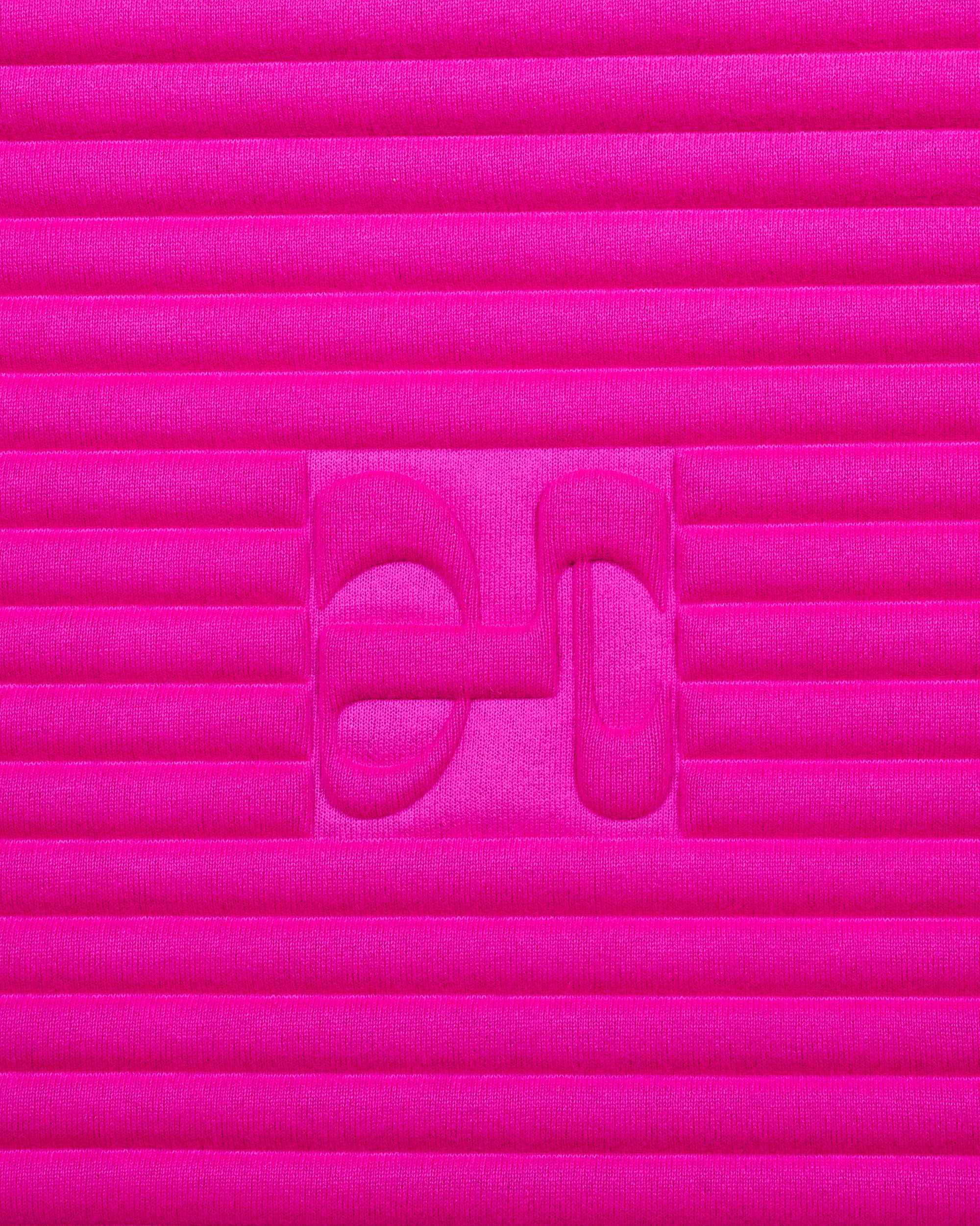 Close-up on the fuchsia pink cashmere texture and embossed H logo of the Hercule Studio x From Future Candy Pink sport mat