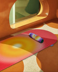 Mini floor mat and comfort pad from Hercule Studio and Uchronia, “Galé” model with ‘Fall’ print, on an Archy sports mat with “Summer Shooting Lifestyle” print, set against a colorful background created by artificial intelligence