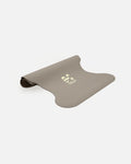 Half-rolled view of the Hercule Studio Greige yoga mat, PVC-free, eco-friendly, comfort and performance for all postures