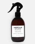 Hercule Studio Probiotic-Enriched Sanitizing Spray for Exercise Mats, a stylish 2-in-1 bottle designed to clean yoga and fitness mats and create an energizing atmosphere, made in France