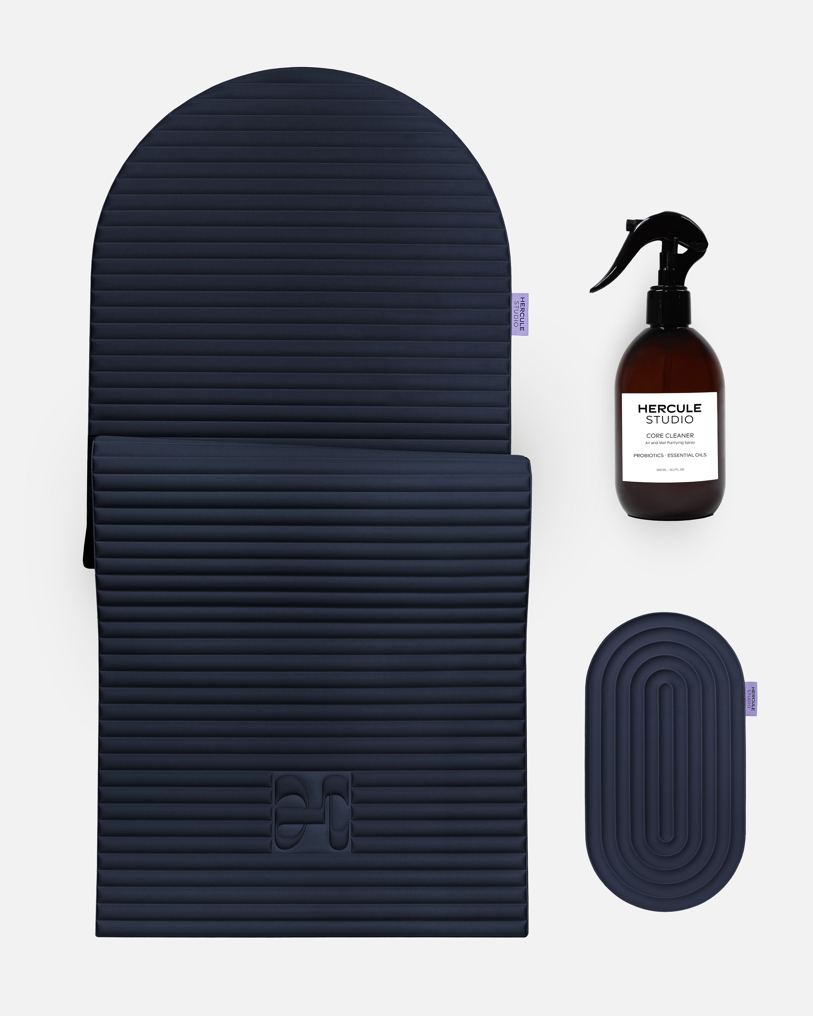 Hercule Studio navy blue essential bundle including the ergonomic Archy mat, the Galé comfort mini mat and the sport mat sanitizing spray, premium Pilates and fitness pack made in France, packshot visual