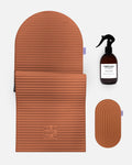 Hercule Studio terracotta essential bundle including the Archy arch-shaped sport mat, the Galé 3-in-1 comfort pad for knees and elbows and the sanitizing spray, durable Made in France Pilates and fitness bundle, packshot of grouped products
